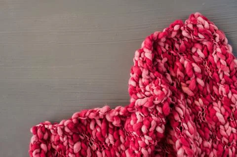 Pink knitting pattern on gray background. Space for text. Stock Photos