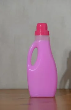 Pink laundry detergent bottle static on indoor wooden surface clean and fre.. Stock Photos