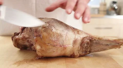 A pink leg of lamb being sliced Stock Footage 24651660