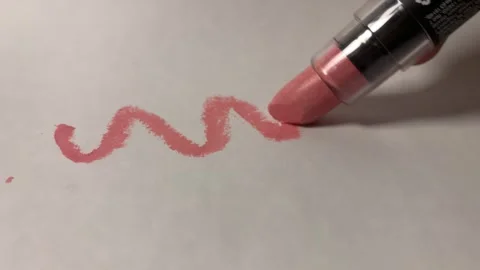 Pink Lipstick Drawing Zigzag Line on Paper in Macro Shot Stock Footage 338388794