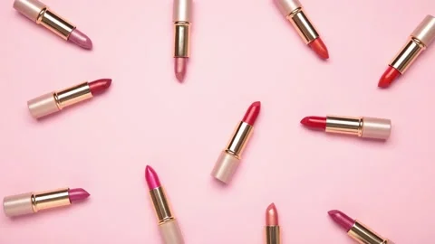 Pink lipsticks moving on pink background - Stop motion.  Stock Footage 134876252