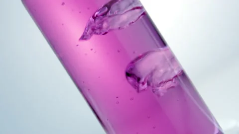 Pink liquid boils in a flask. Stock Footage 238780256