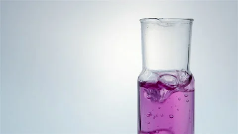 Pink liquid boils in a flask. Stock Footage 238780279
