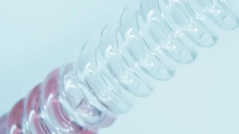 Pink liquid flows down a glass spiral pipe. Stock Footage 248319552