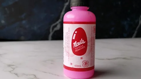 Pink Liquid Nails Cuticle Remover in a Small Container Stock Footage 240903010