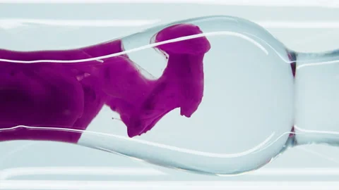 Pink liquid substance flows through a glass flask. Stock Footage 149178043