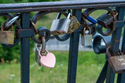 Pink lock in the shape of a heart. Locks for happiness, love and luck. Ritual Stock Photos