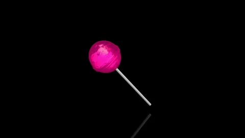 Pink Lollypop turns on itself - loop animation - black background Video stock 255459420
