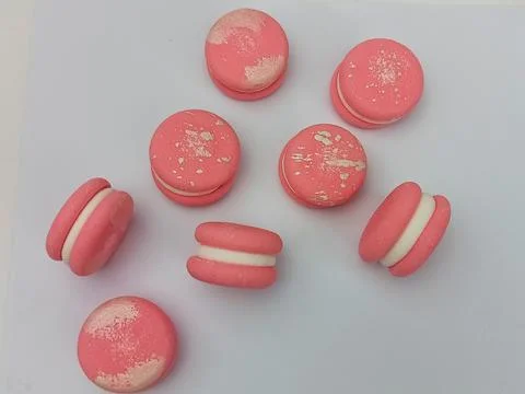 Pink macarons flat lay on white background Stock Photos