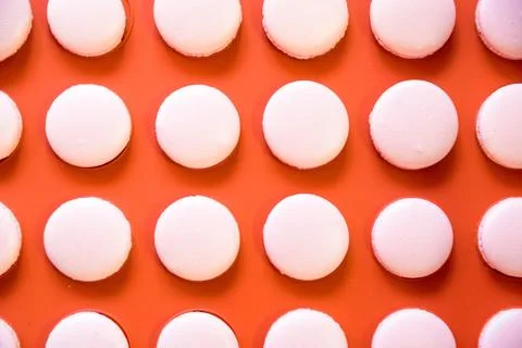 Pink macarons on orange background Stock Photos