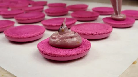 Pink Macaroons halves coated with cream Stock Footage 62426209