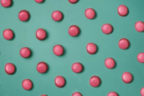 Pink Macaroons pattern on green background Stock Photos