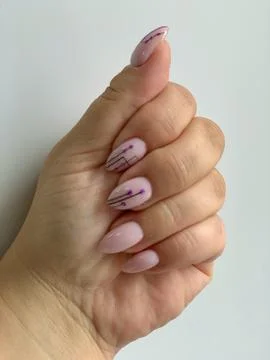 Pink manicure with with black geometric pattern on almond-shaped nails on whi Fotos Stock