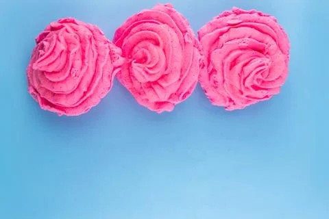 Pink marshmallows on a blue background Stock Photos