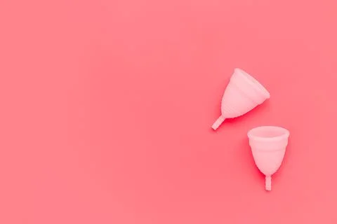 Pink menstrual cup on color background, female intimate hygiene period products Stock Photos
