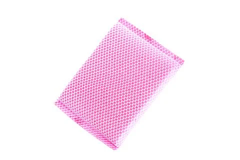 Pink mesh sponge with soft textured surface isolated on white background, used f Stock Photos