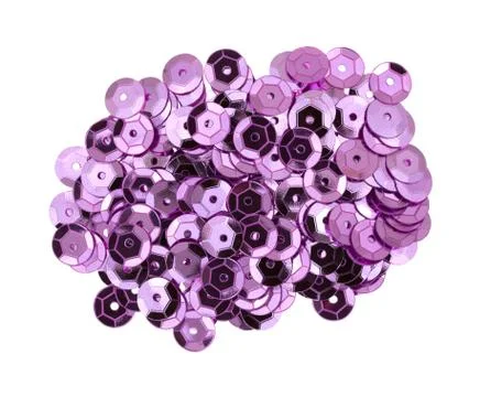 Pink metal sequins on a white background. Stock Photos