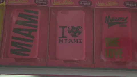 Pink Miami Souvenir iPhone Cases on Retail Display Stock Footage 342563317