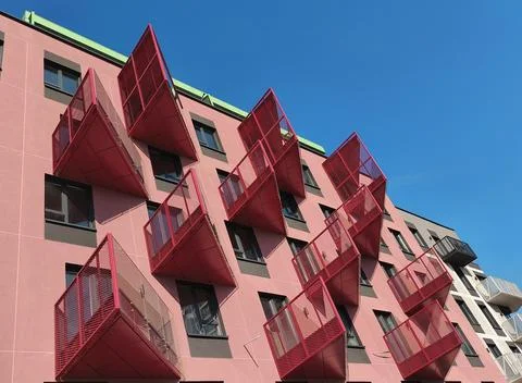 Pink modern building with unusual rectangular balconies in pop art style de.. Фото