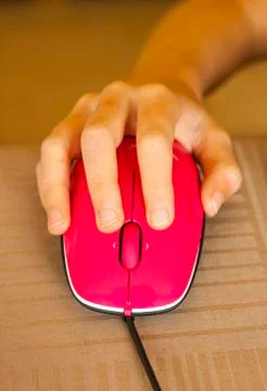 Pink mouse controlled by child hand Foto stock