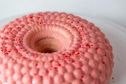 Pink mousse cake in the form of a donut in circles. Stock Photos