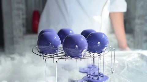 Pink mousse cakes, covered with violet glaze. glossy glaze Stock Footage 79594181