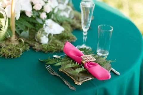 Pink napkin with a patterned clip. table setting. Wedding decor in the magic Stock Photos
