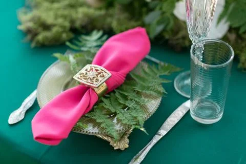 Pink napkin with a patterned clip. table setting. Wedding decor in the magic Stock Photos