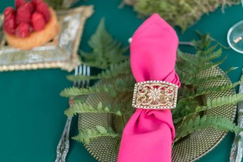 Pink napkin with a patterned clip. table setting. Wedding decor in the magic Stock Photos