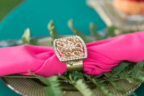 Pink napkin with a patterned clip. table setting. Wedding decor in the magic Stock Photos