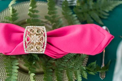 Pink napkin with a patterned clip. table setting. Wedding decor in the magic Stock Photos