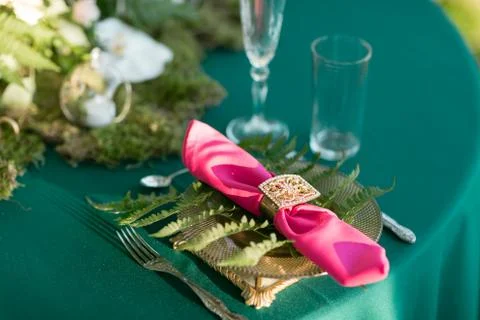 Pink napkin with a patterned clip. table setting. Wedding decor in the magic Stock Photos