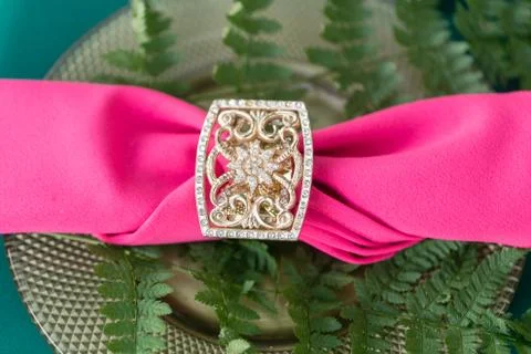 Pink napkin with a patterned clip. table setting. Wedding decor in the magic Stock Photos