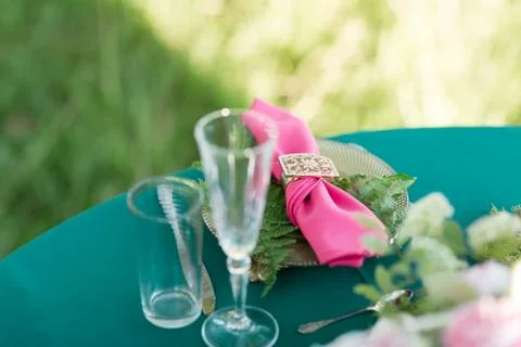 Pink napkin with a patterned clip. table setting. Wedding decor in the magic Stock Photos