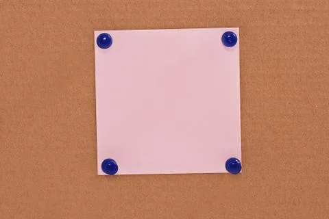 Pink note paper attached with blue pins Stock Photos