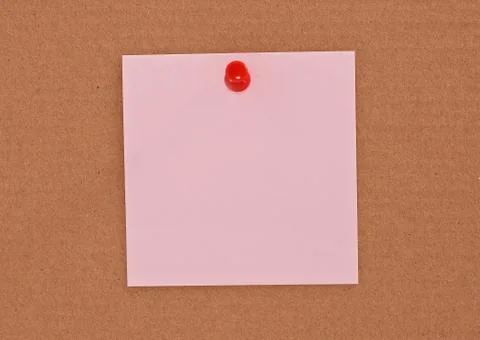 Pink note paper attached with red pin 스톡 사진