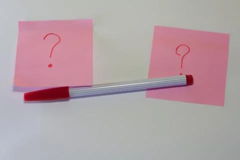 Pink note paper with question marks Stock Photos