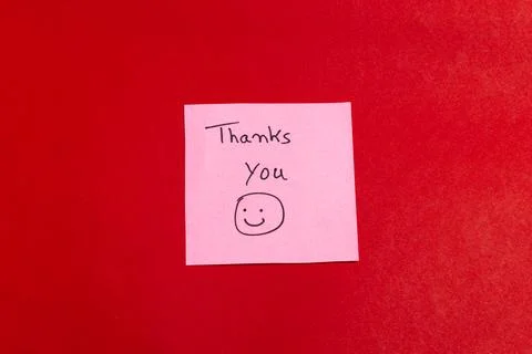 A pink note with a smiley face on it that says "Thank you you" Stock Photos