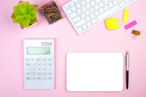 Pink office table with computer, pen and a cup of coffee, lot of things. To.. Stock Photos