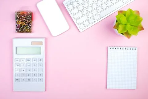 Pink office table with computer, pen and a cup of coffee, lot of things. To.. Stock Photos