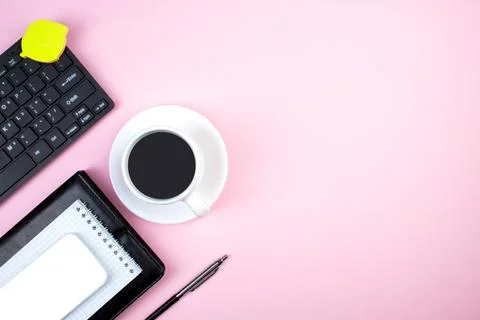 Pink office table with computer, pen and a cup of coffee, lot of things. To.. Stock Photos