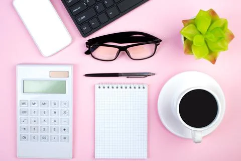 Pink office table with computer, pen and a cup of coffee, lot of things. Top  Stock Photos