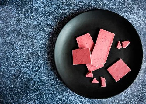 Pink or ruby chocolate, trendy dessert on a black plate, copy space Stock Photos