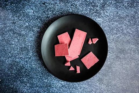 Pink or ruby chocolate, trendy dessert on a black plate Stock Photos