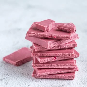 Pink or ruby chocolate, trendy dessert on grey background Stock Photos