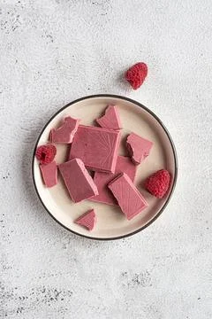 Pink or ruby chocolate, trendy dessert on a white plate Stock Photos