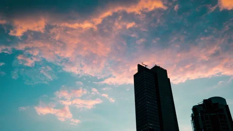 Pink Orange clouds time lapse with building skyscraper, scenic, 4k ProRes 422 HQ Stock Footage 286216627