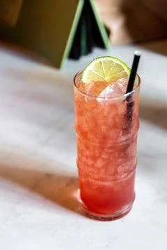 Pink Orange Cocktail Paper Straw on White Marble Table at Bar Copy Space Stock Photos