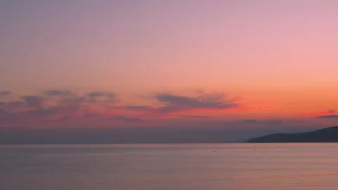 Pink orange lilac sunset on the beach, waves, mountain, horizon, colorful sky an Stock Footage 303893648