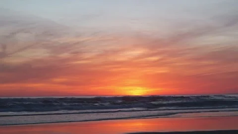 Pink Orange Sunset over Ocean Shore with Soothing Waves and Golden Light Stock Footage 310613926